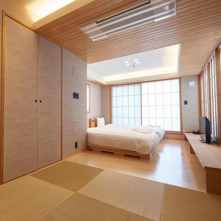 Postel nebo postele na pokoji v ubytování KAMAKURA Hotel