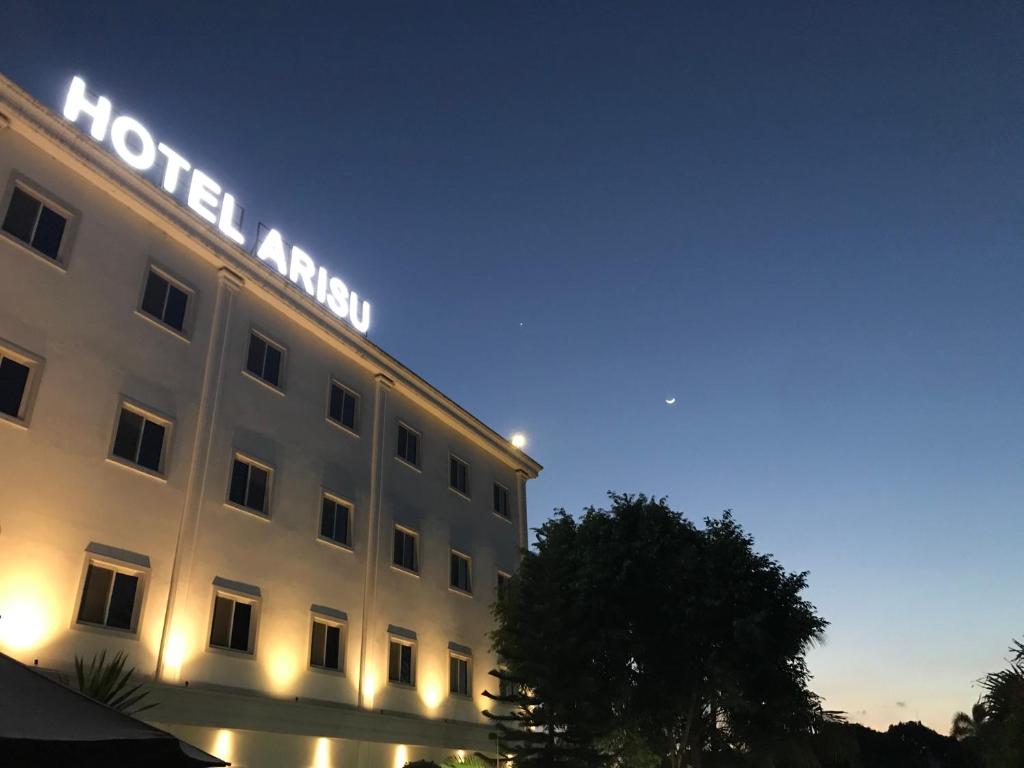 a hotel with a sign on the side of it at Hotel Arisu in Serang