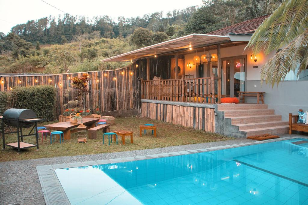 a house with a swimming pool in front of a house at Villa Jeje By The Villas 100 in Bogor
