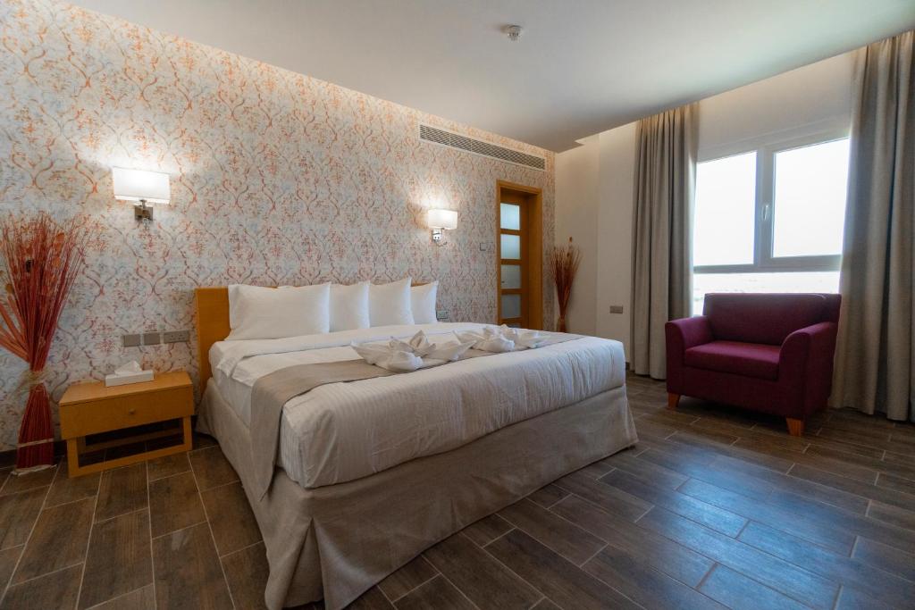 Postel nebo postele na pokoji v ubytování Sama Muscat Hotel