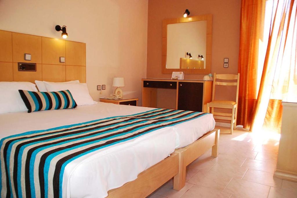 A bed or beds in a room at Ermioni Hotel