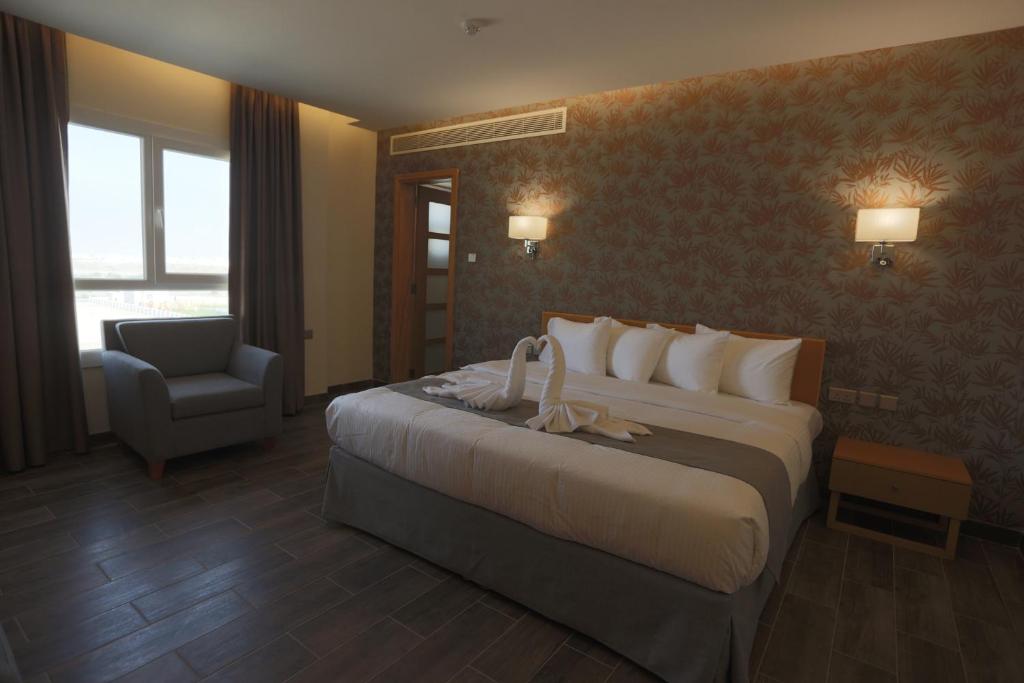 Postel nebo postele na pokoji v ubytování Sama Muscat Hotel