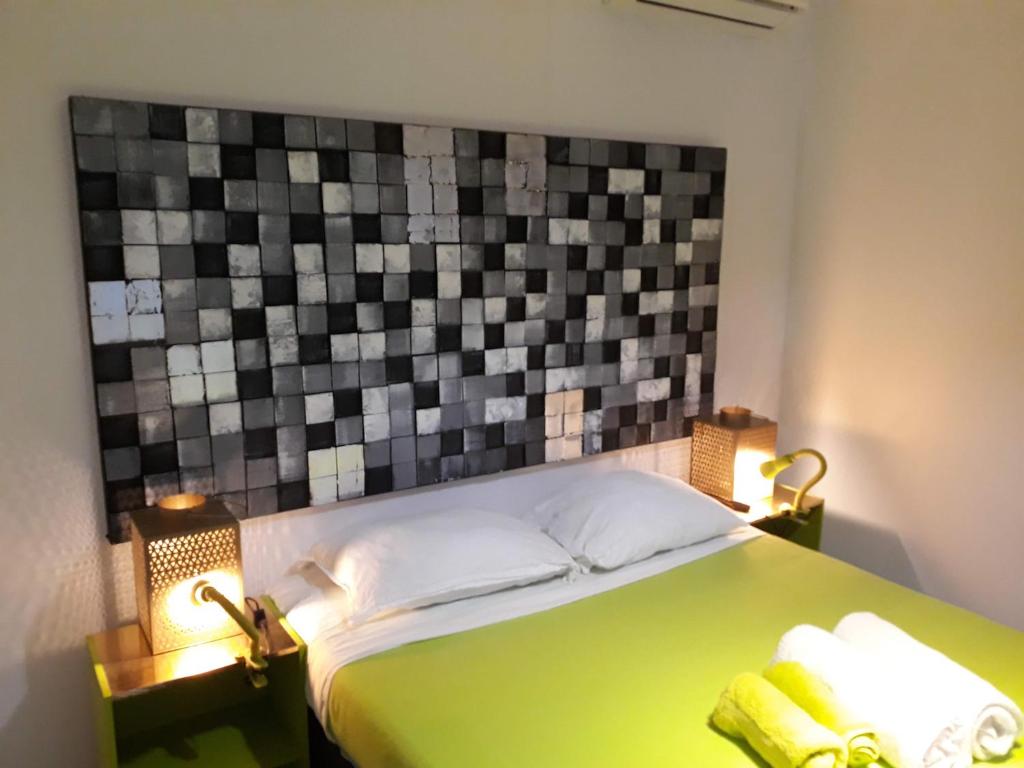 um quarto com uma cama verde com duas toalhas em Villa Eden Rock em Schœlcher