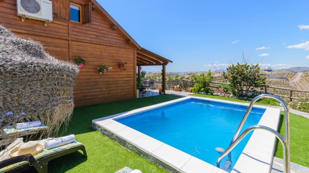 a swimming pool in a yard next to a house at Casa Alegria Almayate Alto by Ruralidays in Almayate Alto
