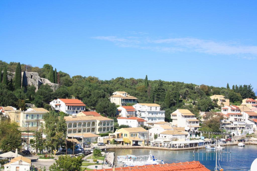 a small town on the shore of a body of water at Porto Kassiopi Apartments in Kassiopi