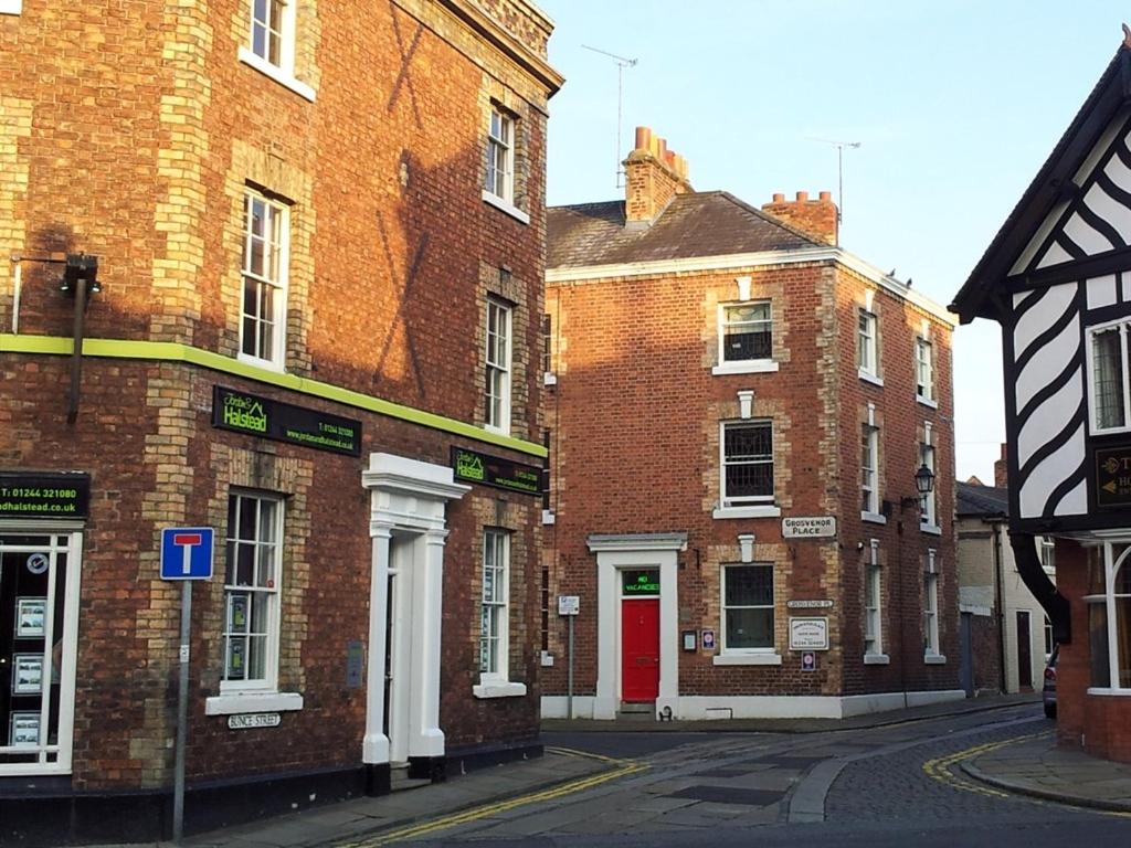 a row of brick buildings on a city street at Grosvenor Place Guest House in Chester