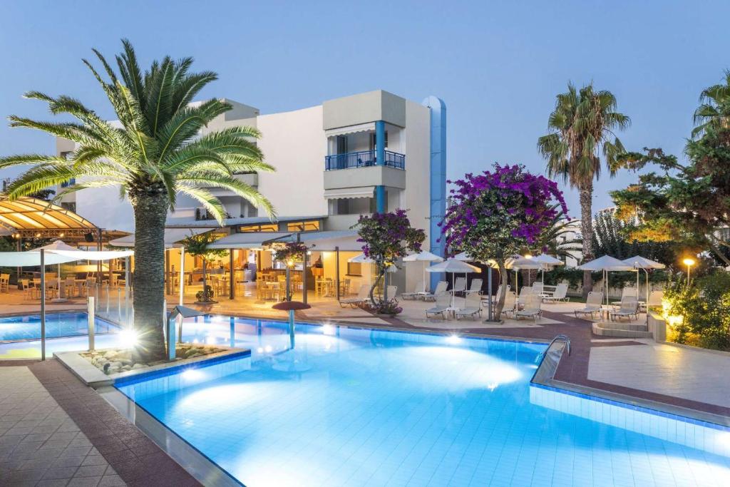 a large swimming pool in front of a building at Ibiscos Garden Hotel in Rethymno