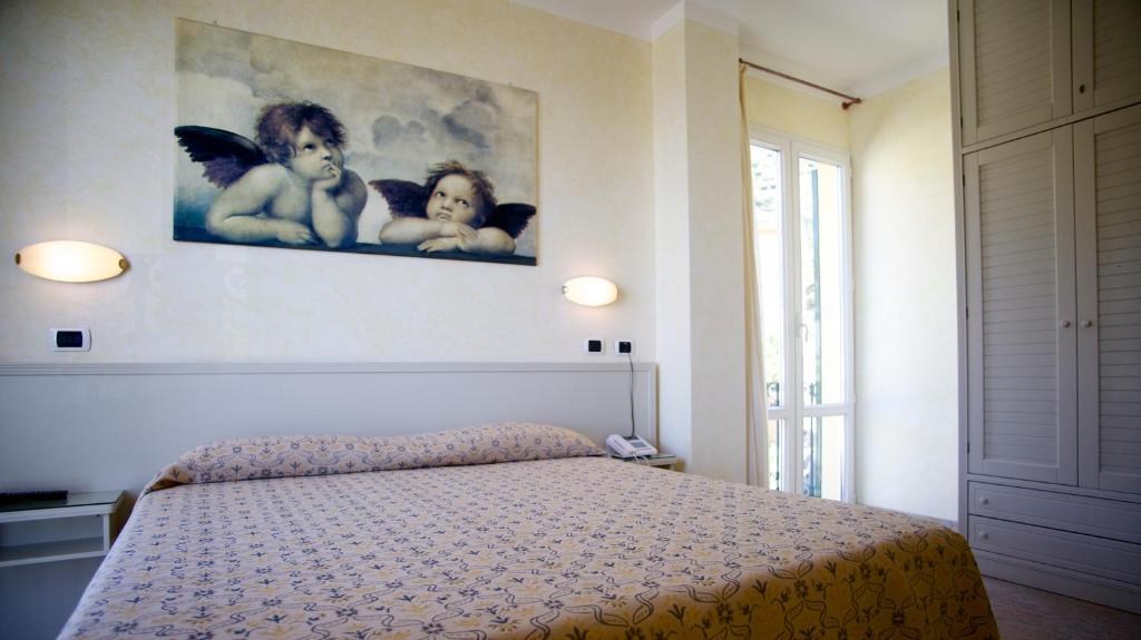 Postel nebo postele na pokoji v ubytování Hotel Feluca