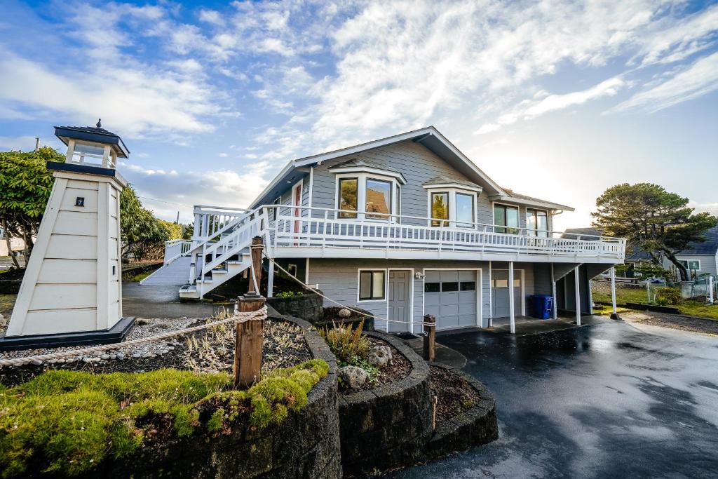 a lighthouse in front of a house at The Chinook House in Depoe Bay