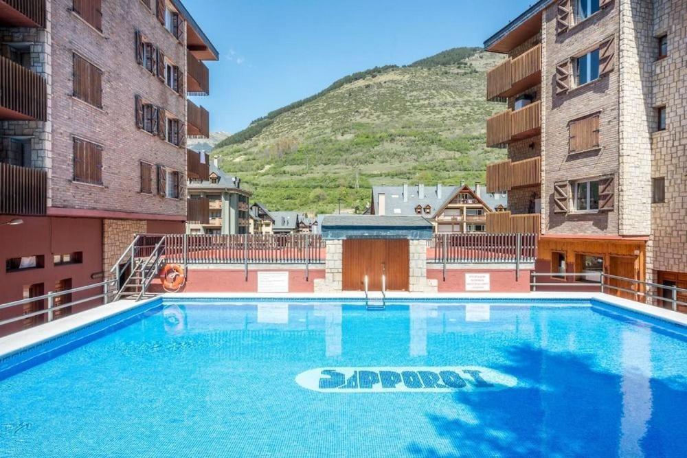 a large swimming pool in the middle of two buildings at Estudio 2-4 personas en Vielha-Baqueira in Vielha
