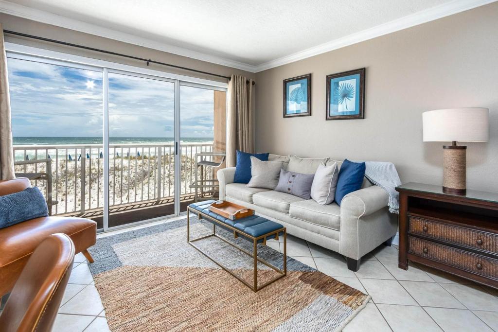 a living room with a couch and a view of the ocean at Islander in Fort Walton Beach