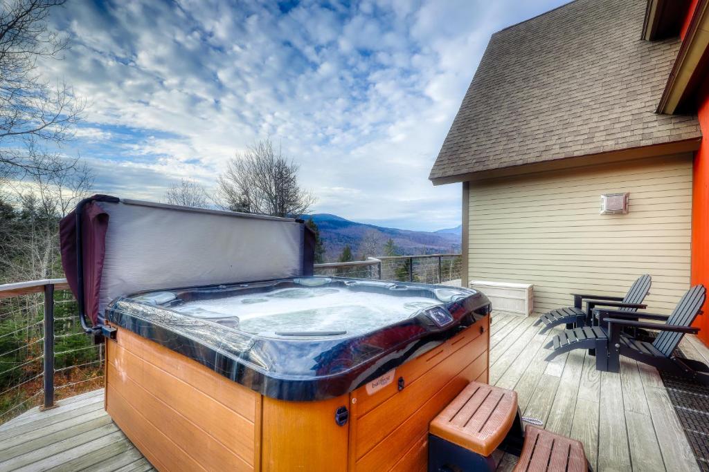 a hot tub on the deck of a house at Thunder Ridge Lodge in Newry