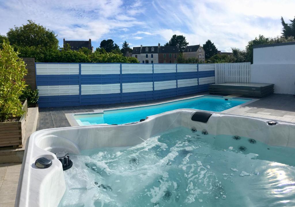 a large bath tub filled with blue water at Villa Garance Ile et Villas Groix in Groix