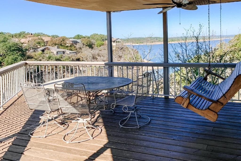 a patio with a table and chairs on a deck at Spicewood Treehouse in Spicewood