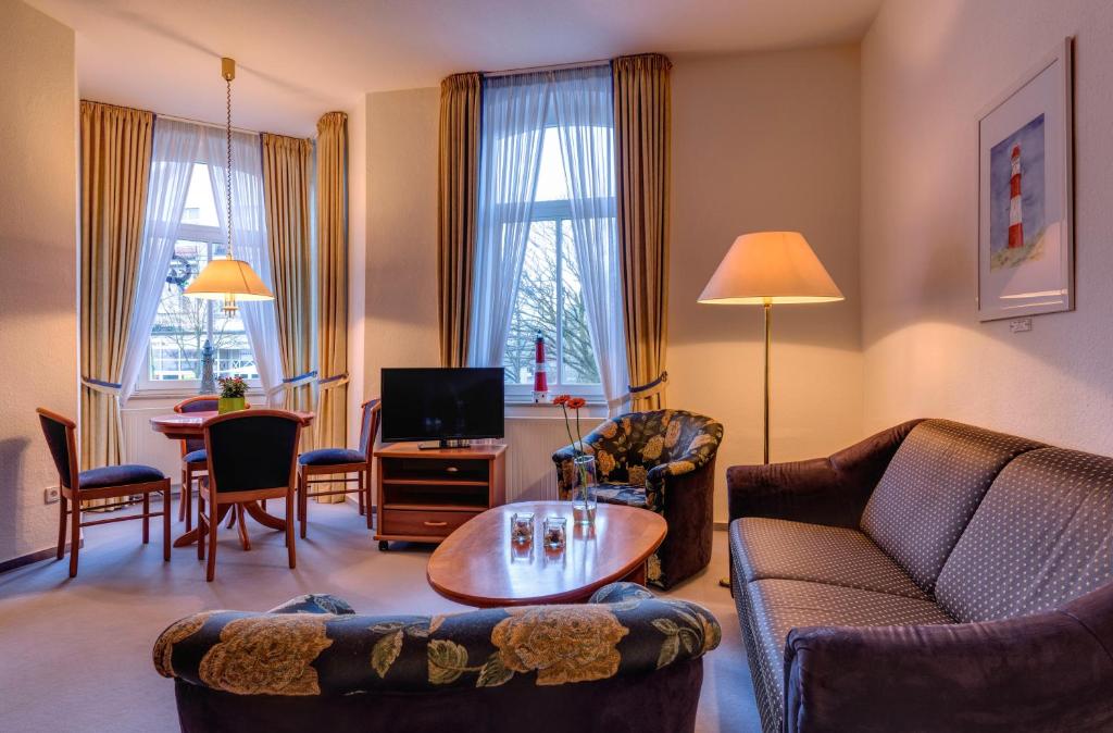 a living room with a couch and chairs and a table at Hotel Aquamarin in Kühlungsborn