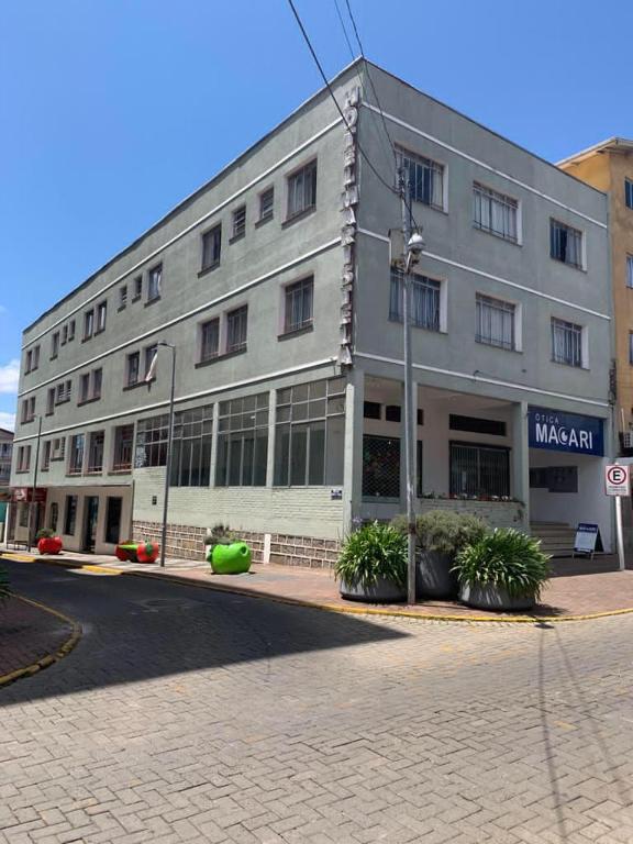 a large white building on a city street at Hotel Maristela in São Joaquim