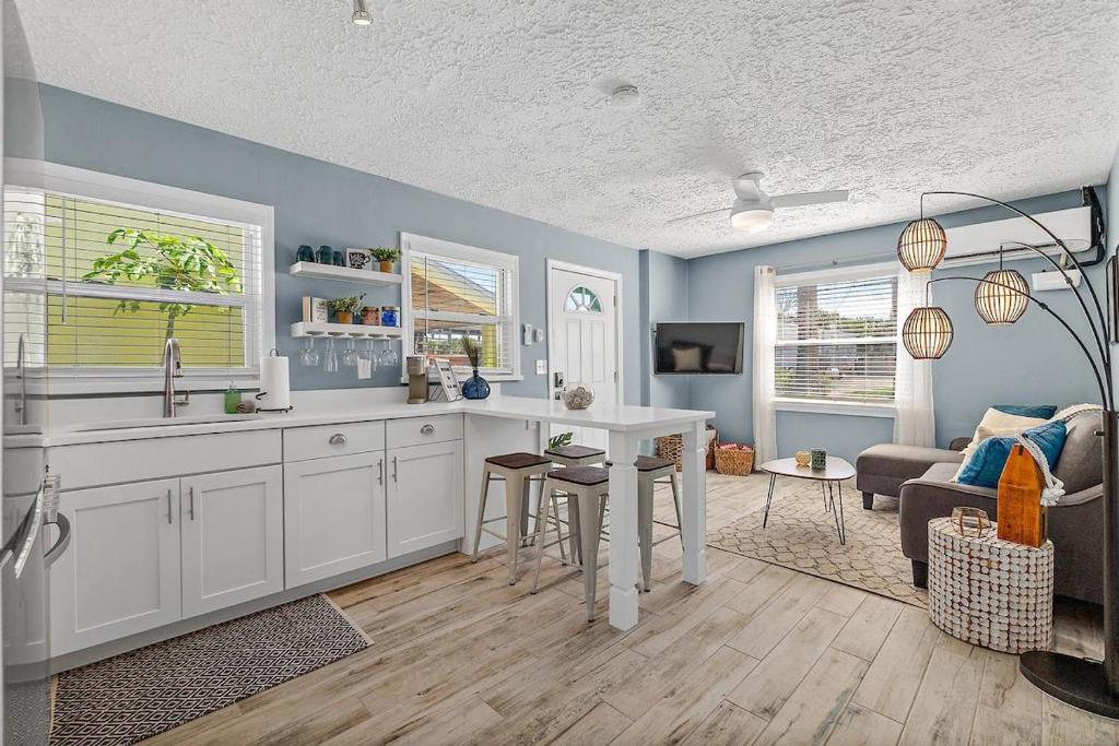 a kitchen with a sink and a table in a room at Déjà Blue - Steps to the Ocean! in Saint Augustine