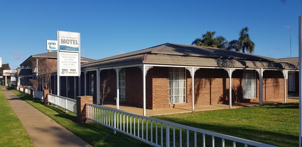 a brick building with a sign in front of it at Centrepoint Motel Deniliquin in Deniliquin