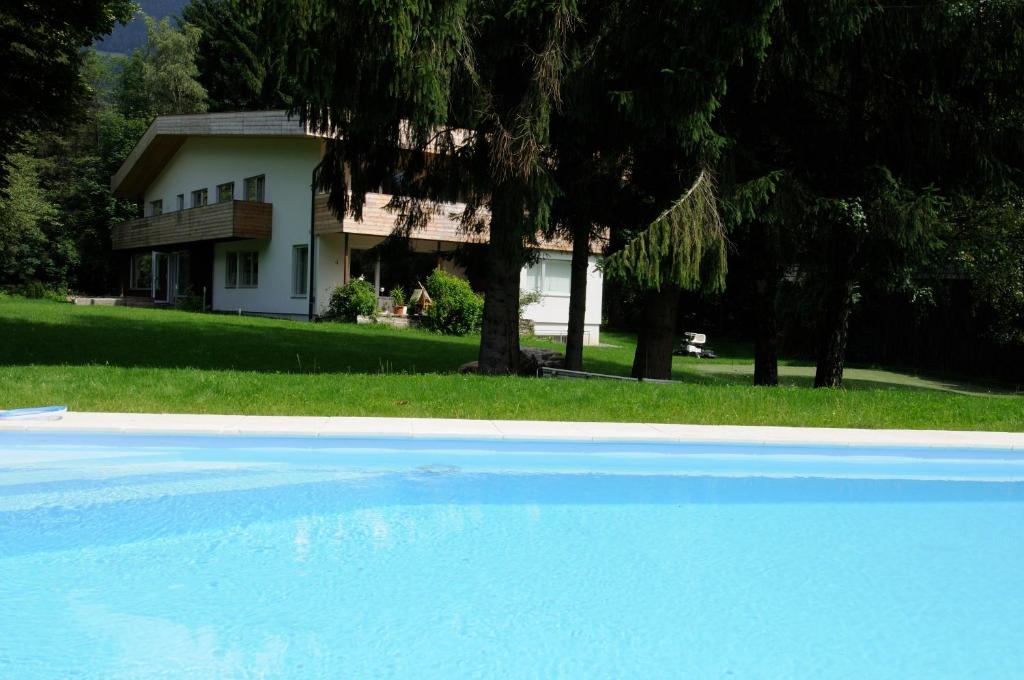 a house with a swimming pool in front of a house at Lärchenhof in Afritz