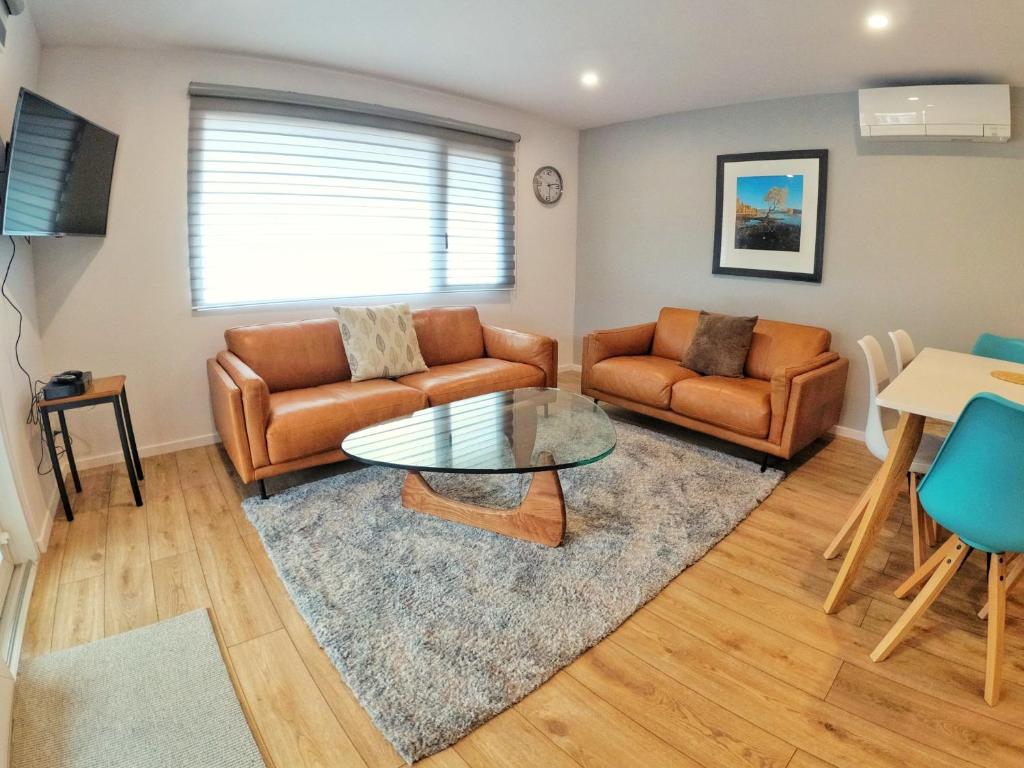 a living room with a couch and a table at Aspiring Apartment Wanaka in Wanaka