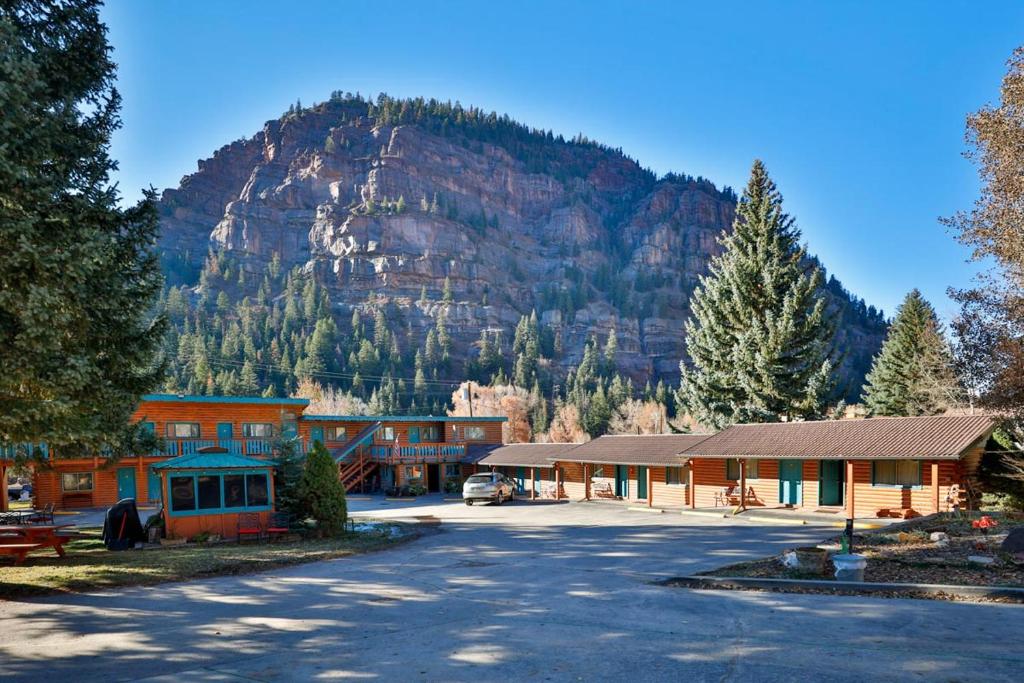 a building with a mountain in the background at Ouray Inn in Ouray