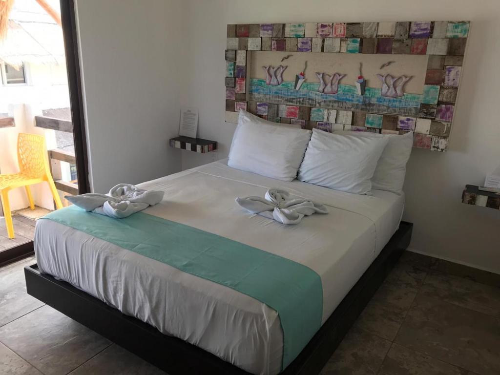 Postel nebo postele na pokoji v ubytování Hotel Blue Reef frente al mar