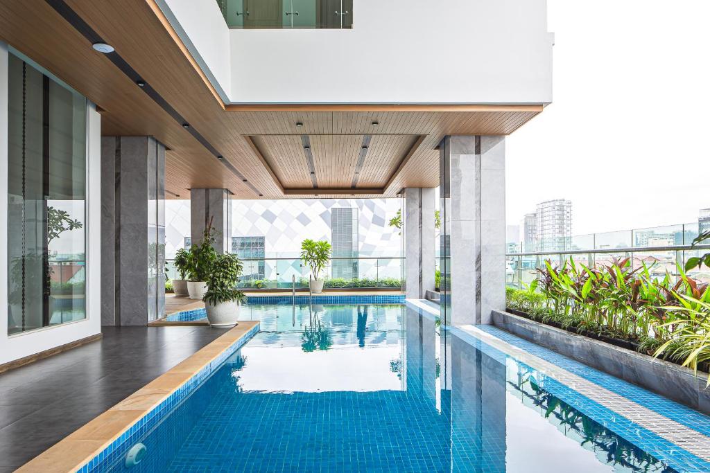 a swimming pool in the middle of a building at Sensory Park Urban Hotel in Phnom Penh