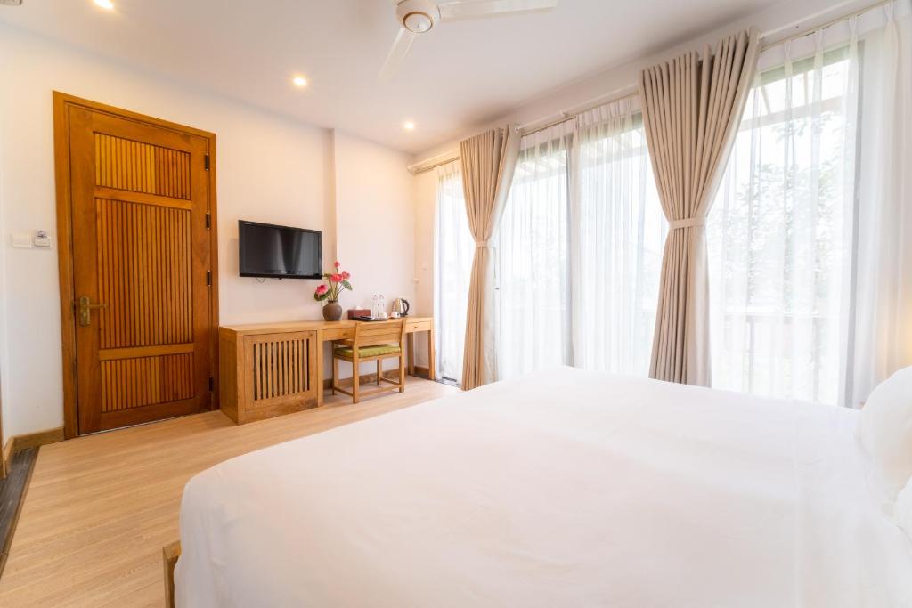 Postel nebo postele na pokoji v ubytování ZEN Boutique Hoi An - Eco-Friendly Villa