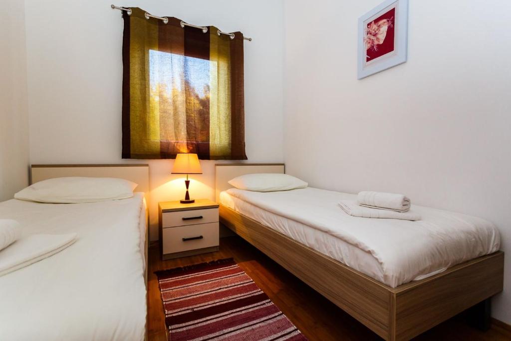Postel nebo postele na pokoji v ubytování Apartments Adria