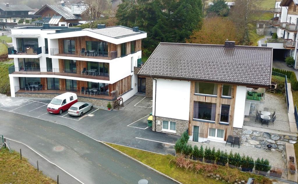 a house with a car parked in a parking lot at Appartement Kitzsteinhorn in Kaprun