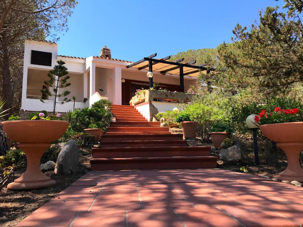 a house with stairs leading up to a house at Villa Maddalena - Giardinelli in La Maddalena