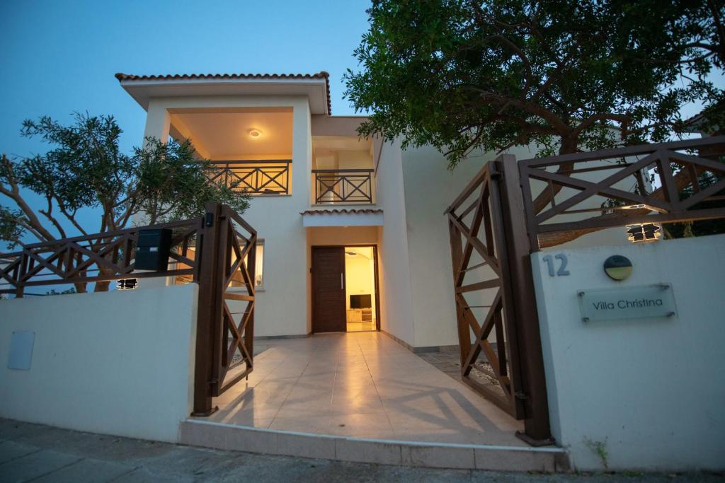 a villa with a gate in front of a house at Villa Arsinoe by Agroholidays in Pissouri