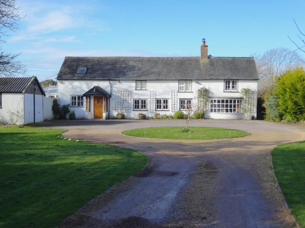 a large white house with a driveway at Hunters Croft in Sway