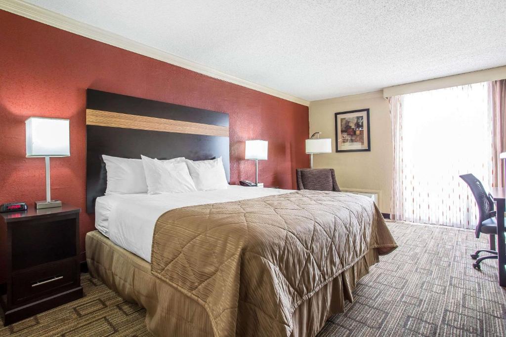 a hotel room with a large bed and a window at Clarion Hotel Fort Mill Near Amusement Park in Fort Mill