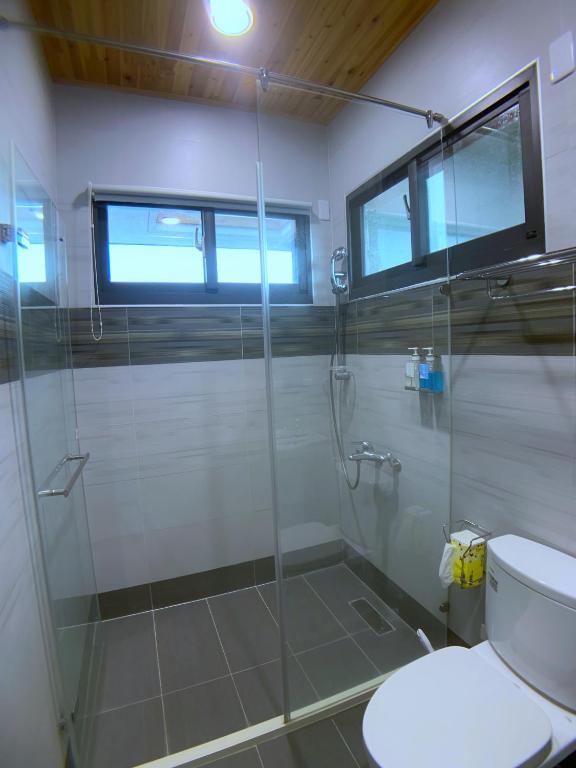 a bathroom with a shower and a toilet at EZE Homestay in Ji&#39;an