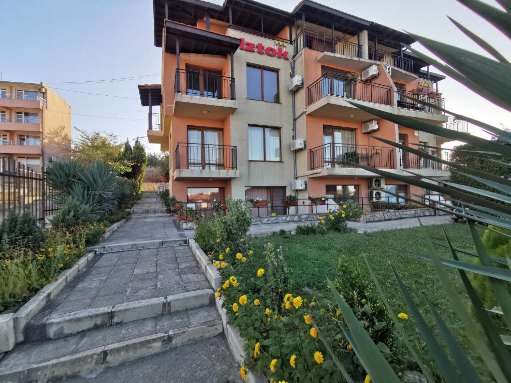 a building with a garden in front of it at Villa Iztok in Sozopol