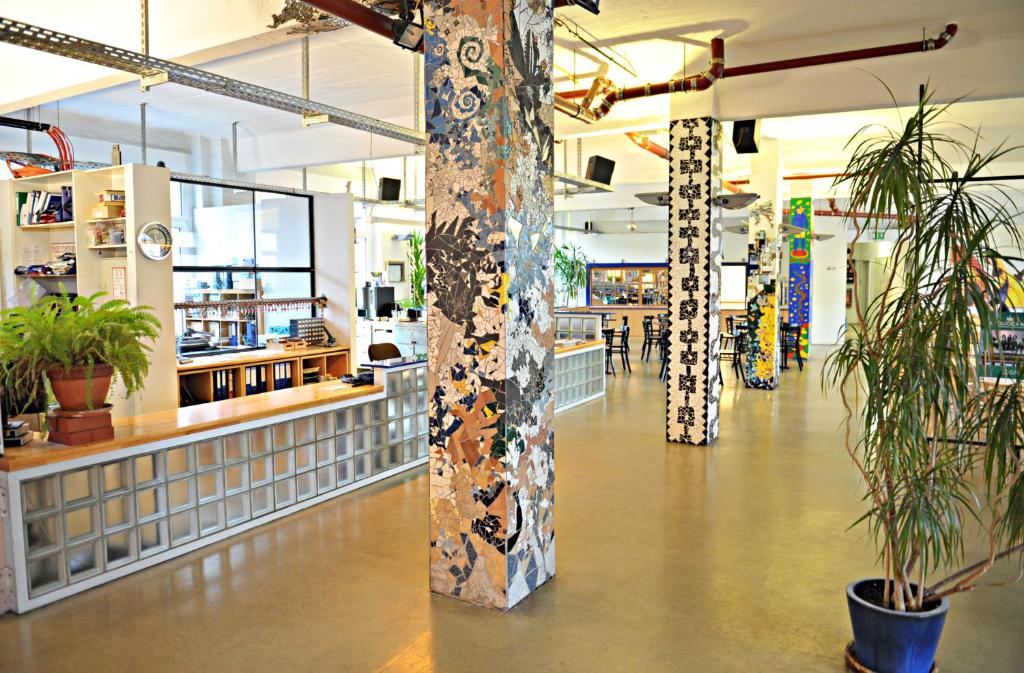 a store aisle with columns and plants in a store at Hotel Transit Loft in Berlin