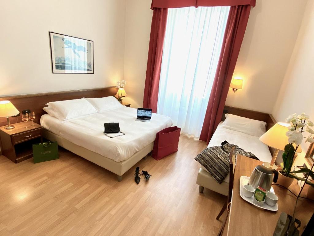 Postel nebo postele na pokoji v ubytování Hotel Eletto