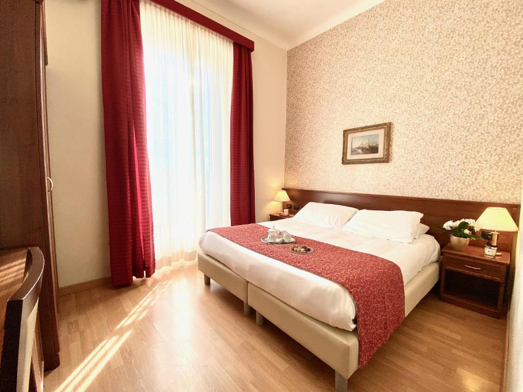 Postel nebo postele na pokoji v ubytování Hotel Eletto