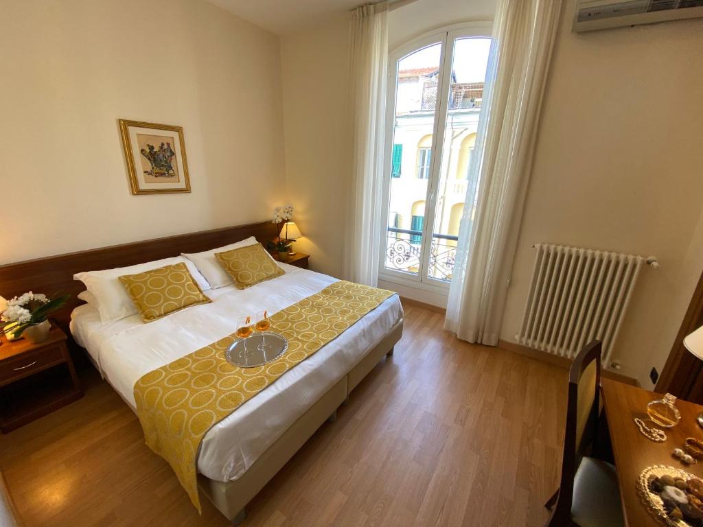 Postel nebo postele na pokoji v ubytování Hotel Eletto