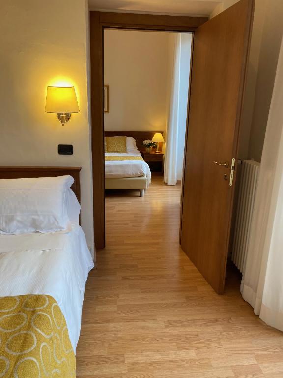 Postel nebo postele na pokoji v ubytování Hotel Eletto