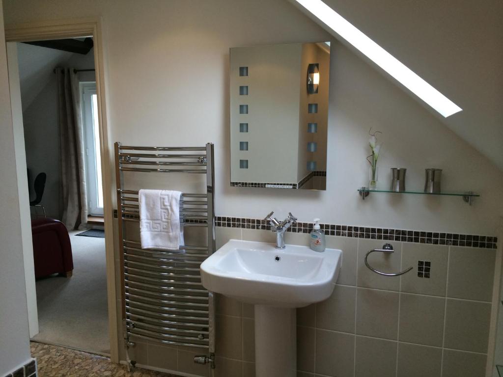 a bathroom with a sink and a mirror at Southover Beach in Woolacombe