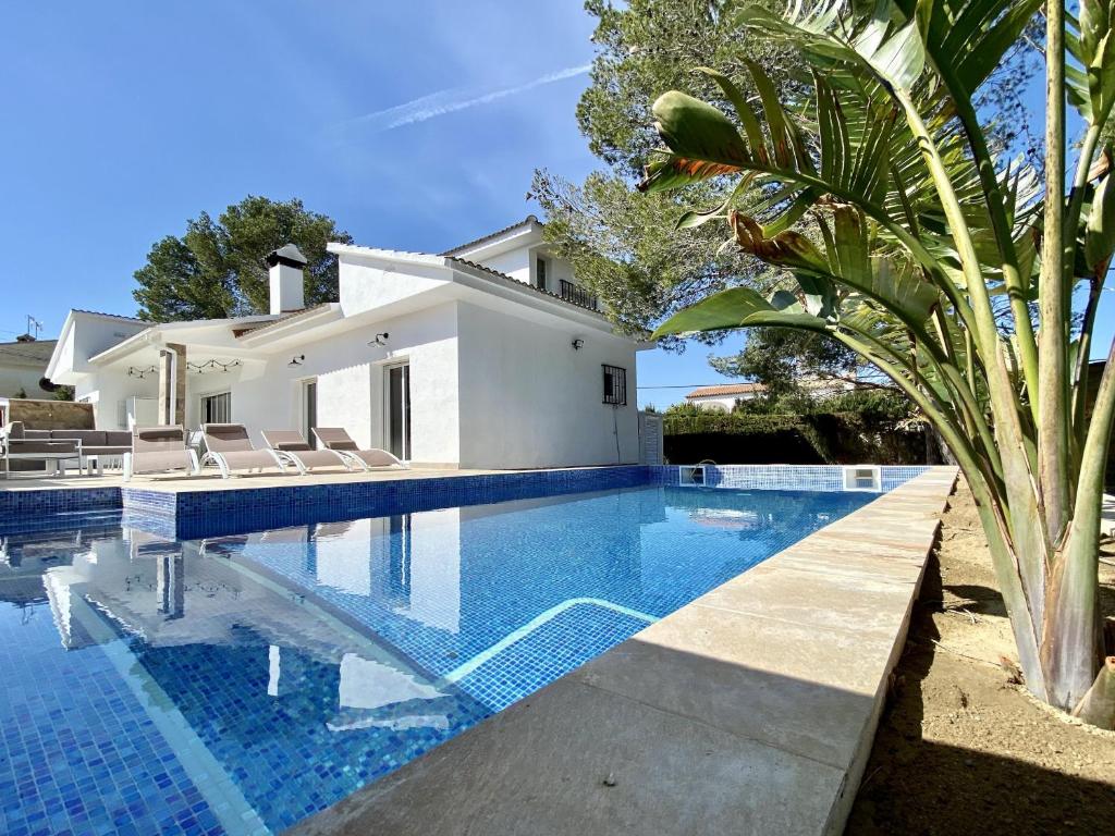 a swimming pool in front of a villa at Villa Bouganvilla luxury villa with air-con, & private swimming pool ideal for families in L'Ametlla de Mar