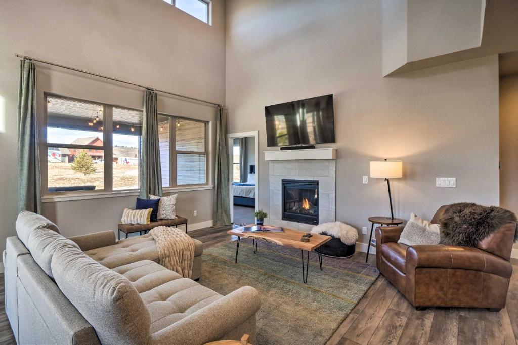 a living room with two couches and a fireplace at Home with Private Hot Tub Near Skiing and Rocky Mtn NP in Granby