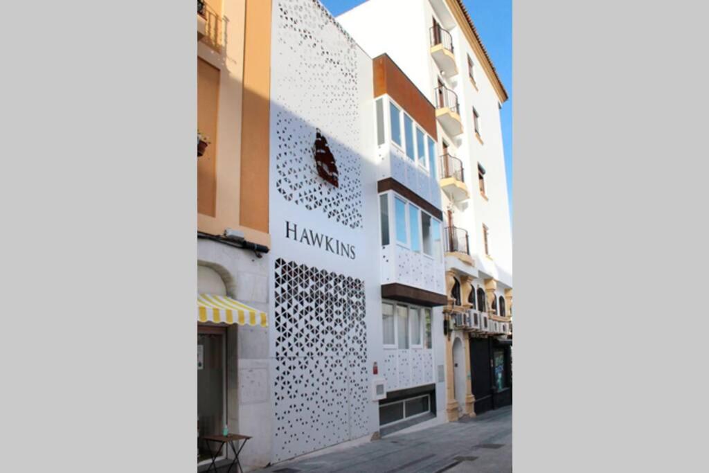 a building with a sign on the side of it at Apartamento interior en el centro de Algeciras 2A in Algeciras