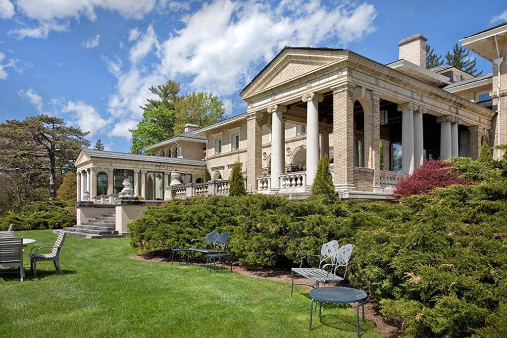 a large house with chairs in the yard at Wheatleigh in Lenox