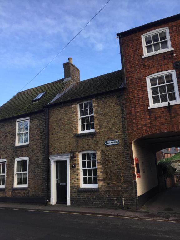 a brick house with an archway on a street at 5 Union Road in Lincoln