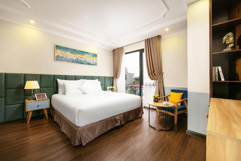 Postel nebo postele na pokoji v ubytování C'Bon Hotel Do Quang