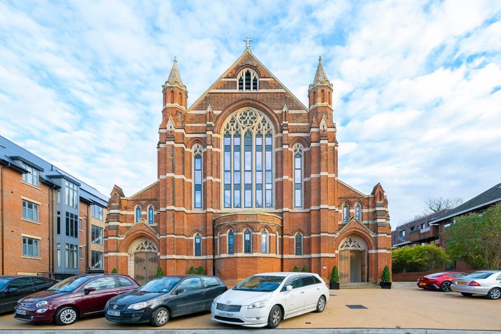a large church with cars parked in front of it at Luxury Romantic Church Getaway in Finchley