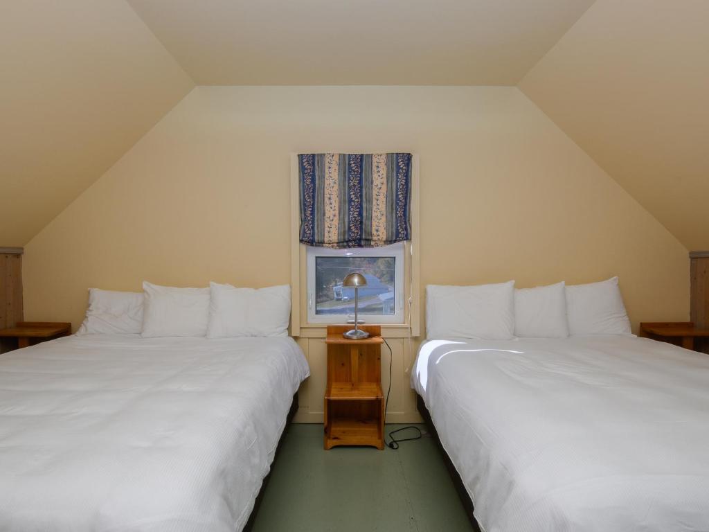 Postel nebo postele na pokoji v ubytování Au Pic de l'Aurore Motel-Chalets